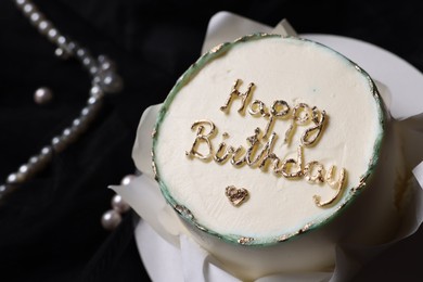 Delicious decorated Birthday cake on black background, closeup