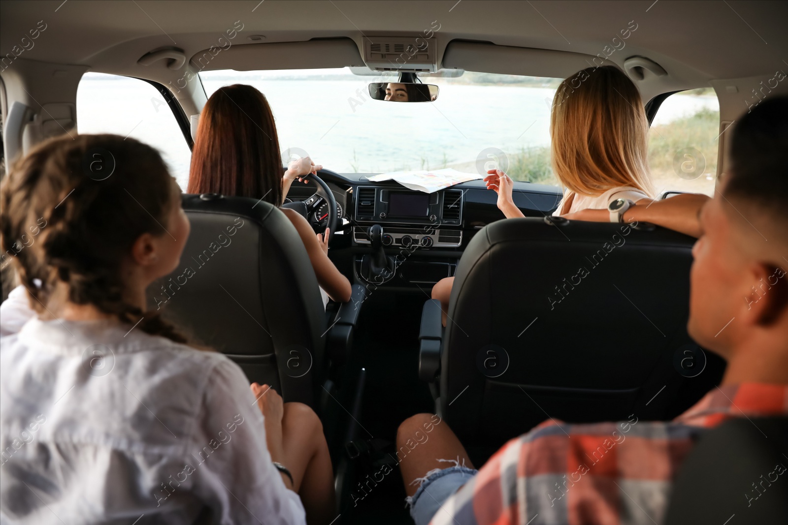 Photo of Happy friends together in car on road trip