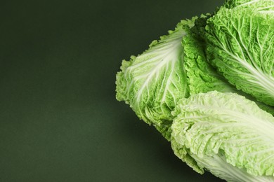 Photo of Fresh ripe Chinese cabbages on green background, above view. Space for text