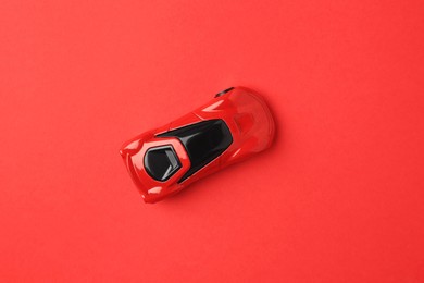 Photo of One bright car on red background, top view