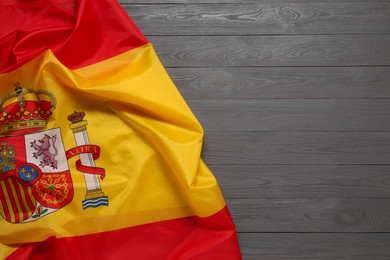 Photo of Flag of Spain on gray wooden background, top view. Space for text