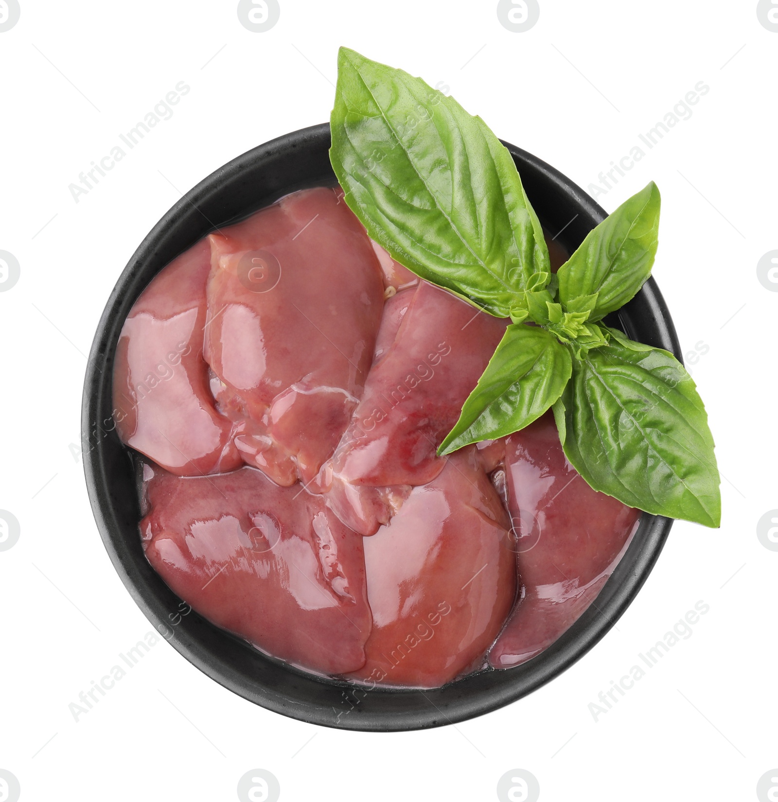 Photo of Bowl of raw chicken liver with basil isolated on white, top view