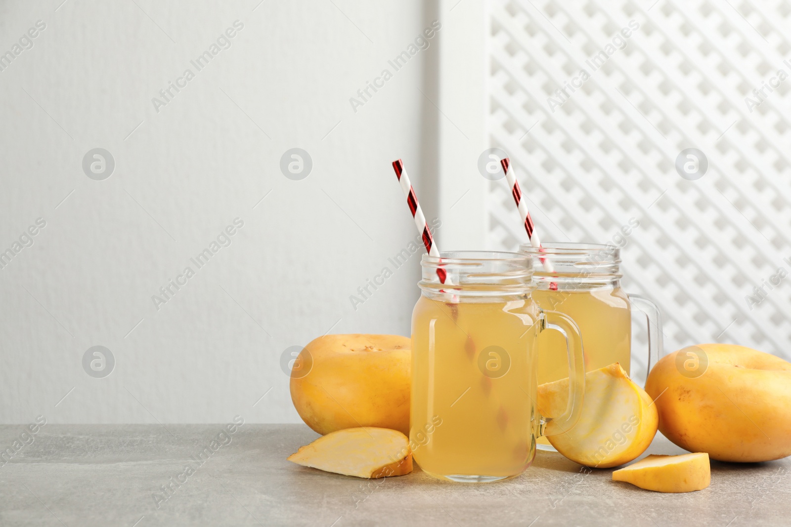 Photo of Freshly made turnip juice on light grey table, space for text