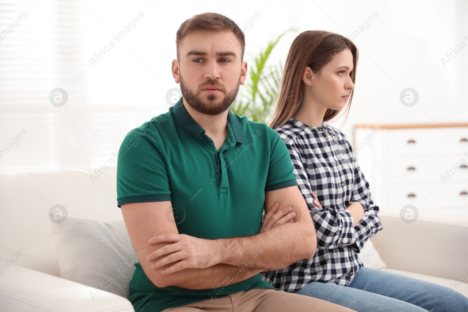 Photo of Stubborn man and woman with problems in relationship at home