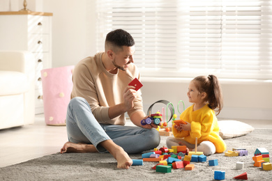 Father playing with his child at home