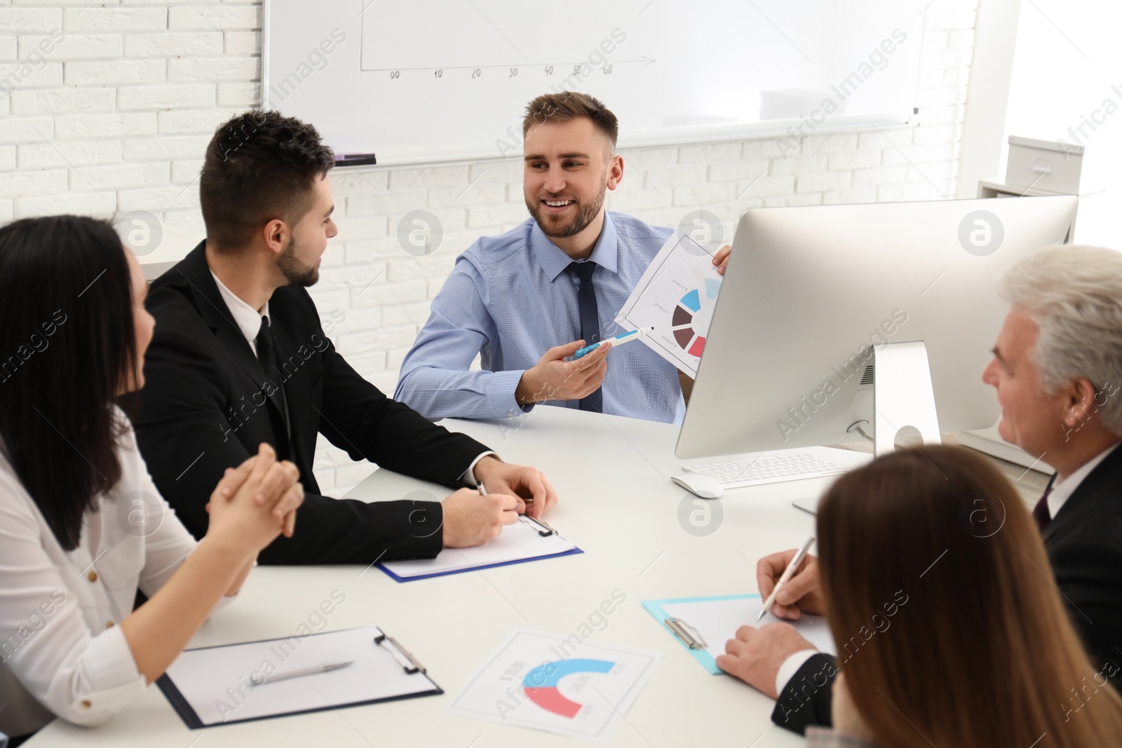 Photo of Professional business trainer working with people in office