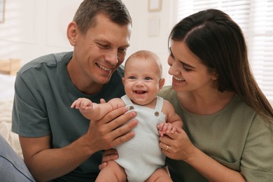 Happy family with their cute baby at home