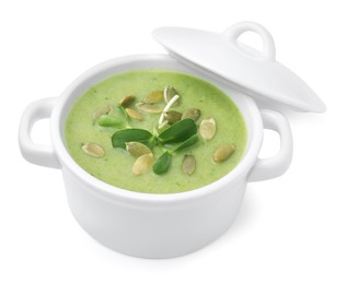 Delicious broccoli cream soup with pumpkin seeds isolated on white