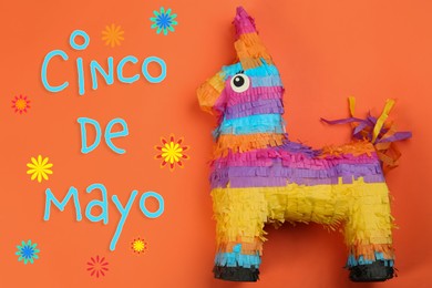Cinco de Mayo festive poster. Bright funny pinata on orange background, top view