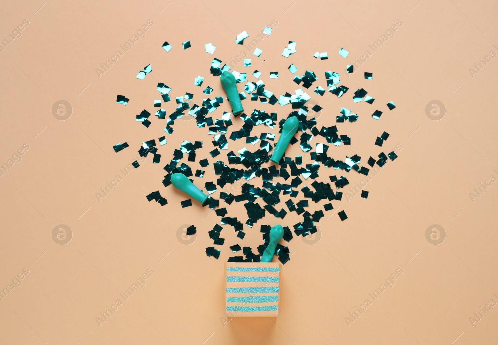 Photo of Flat lay composition with colorful confetti and box on beige background