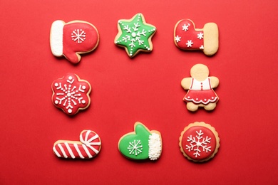 Frame made with tasty homemade Christmas cookies on red background, flat lay. Space for text