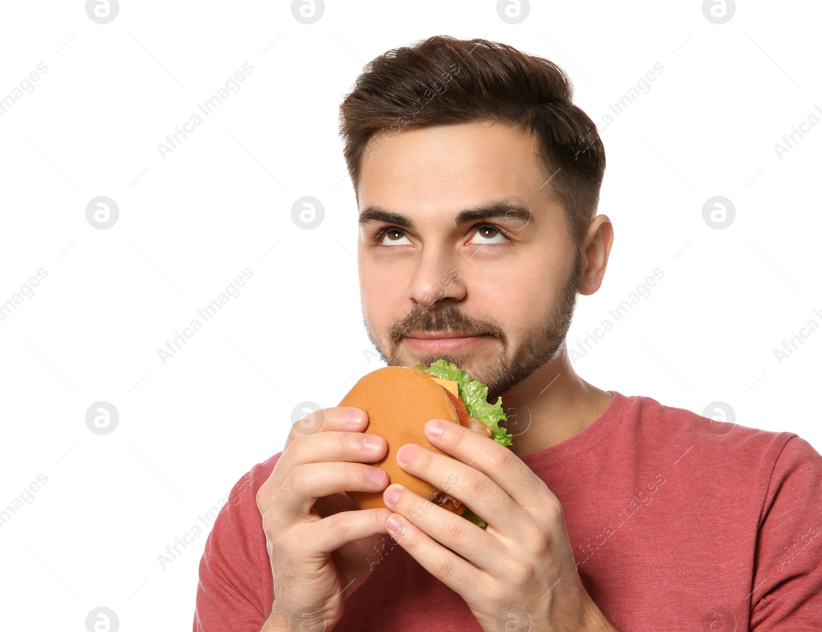 Photo of Handsome man eating tasty burger isolated on white