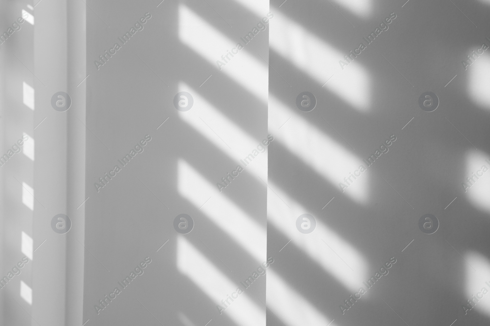 Image of Light and shadows falling on white wall