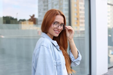 Portrait of beautiful woman in glasses outdoors