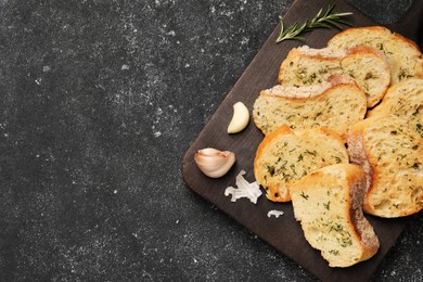 Tasty baguette with garlic, dill and rosemary on grey textured table, top view. Space for text