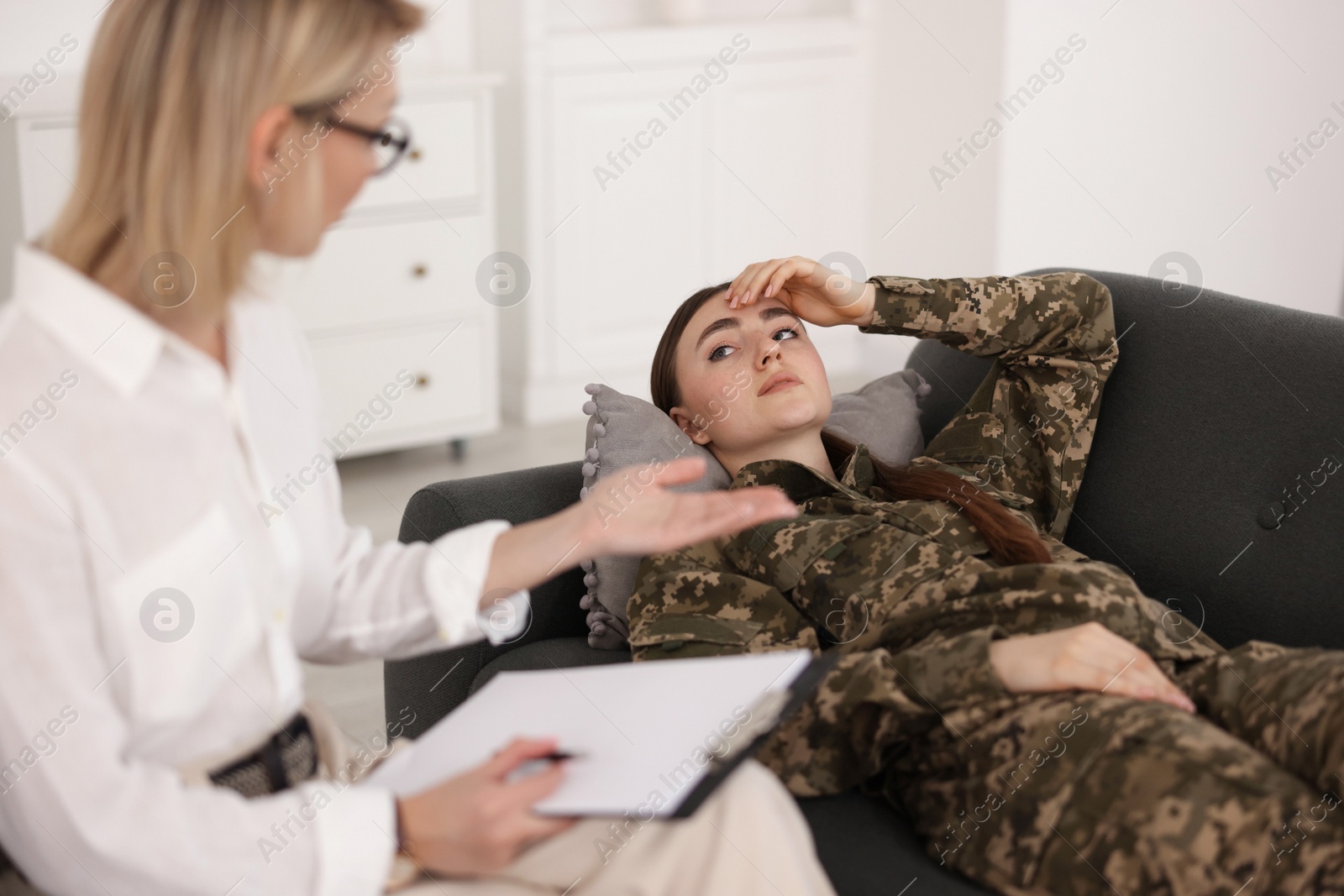 Photo of Psychotherapist working with military woman in office