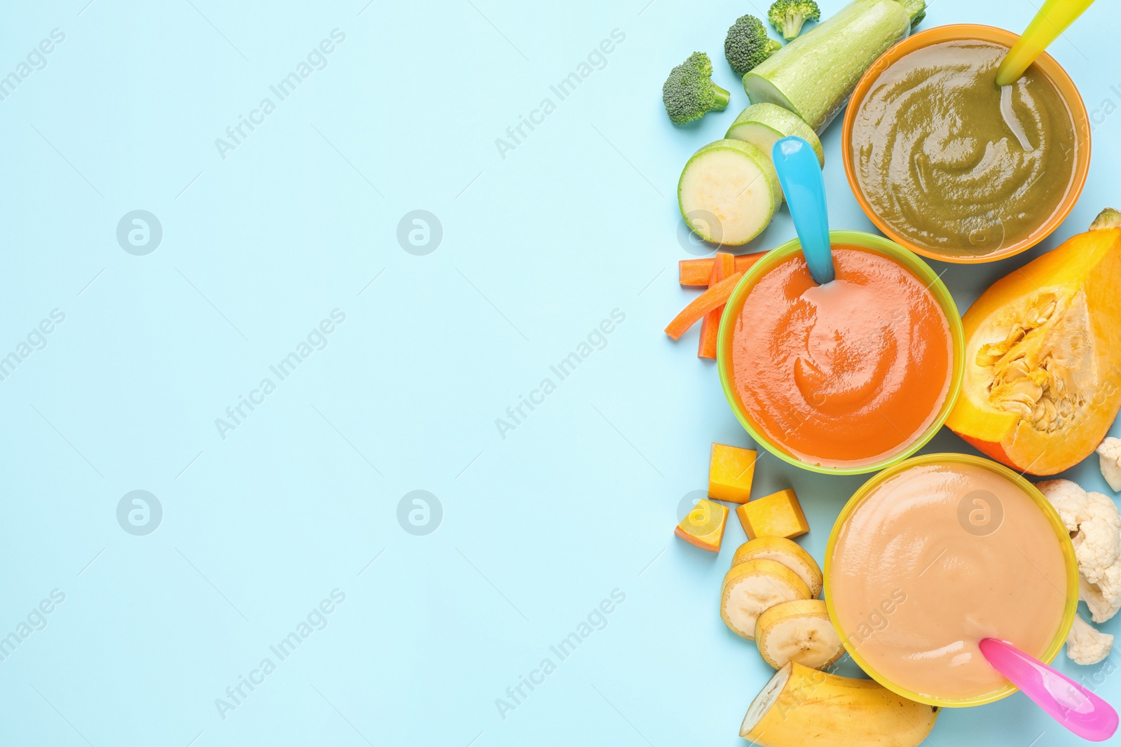 Photo of Healthy baby food and ingredients on light blue background, flat lay. Space for text