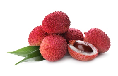 Pile of fresh ripe lychees with green leaves on white background