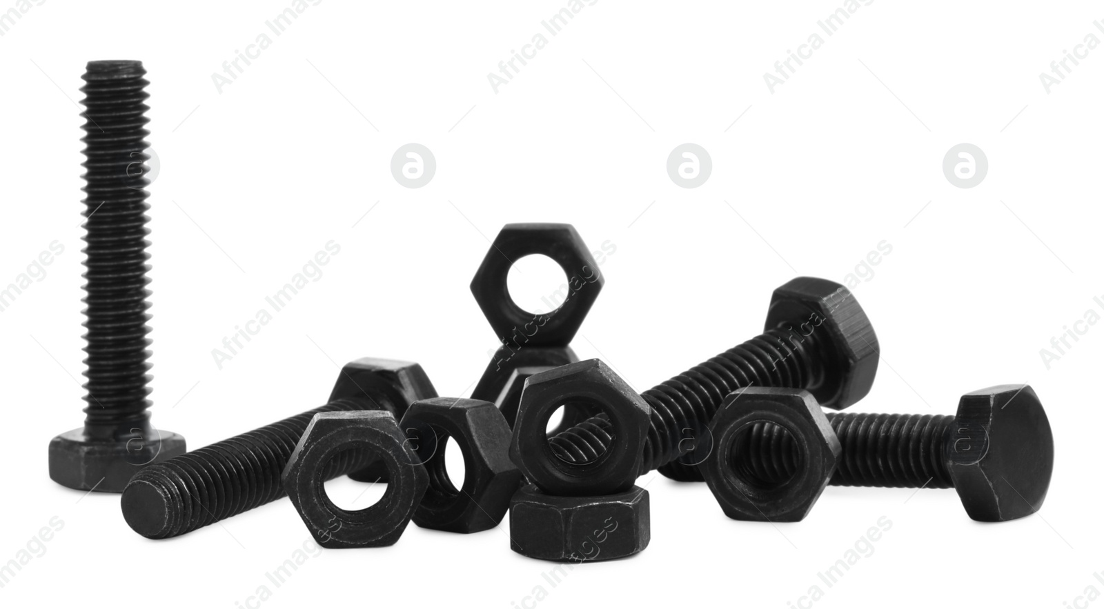 Photo of Different black metal bolts and nuts on white background