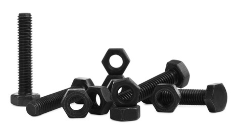 Photo of Different black metal bolts and nuts on white background