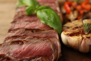 Delicious grilled beef steak with spices on table, closeup