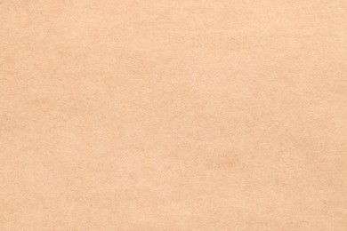 Photo of Texture of beige paper sheet as background, top view