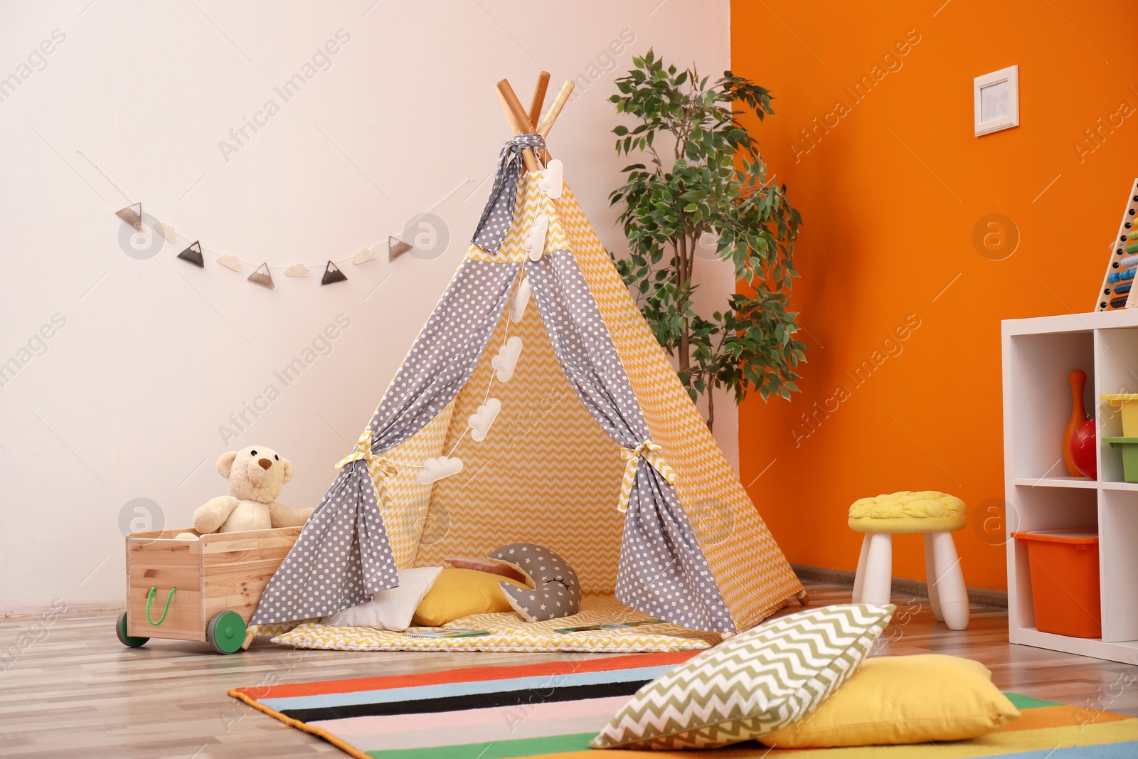 Photo of Cozy kids room interior with play tent and toys