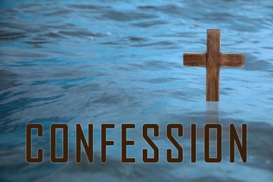 Word Confession near wooden Christian cross in water