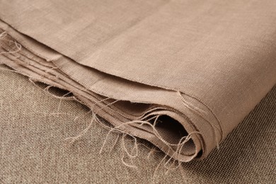 Photo of One folded light brown fabric on cloth, closeup