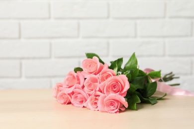 Bouquet of beautiful roses on table