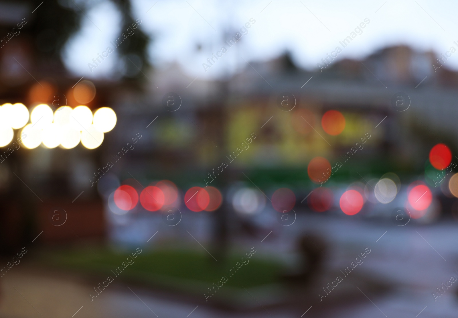 Photo of Blurred view of modern city at evening. Bokeh effect