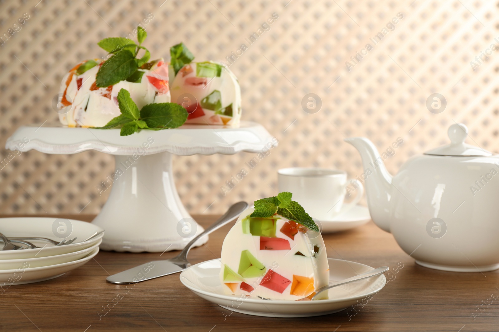 Photo of Delicious broken glass jelly dessert on wooden table