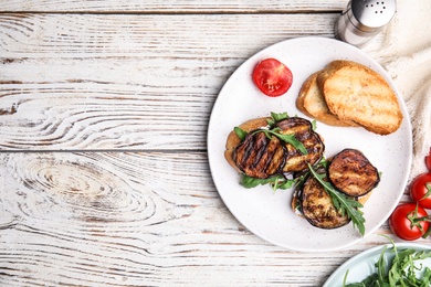 Delicious eggplant sandwiches served on white wooden table, flat lay. Space for text