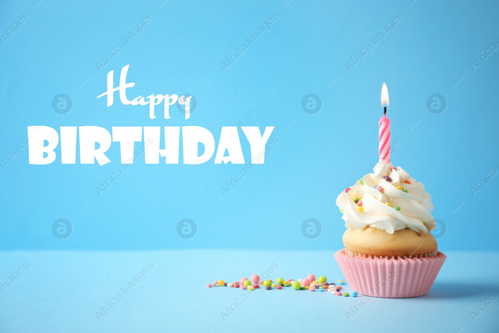 Image of Delicious cupcake with candle on light blue background. Happy Birthday