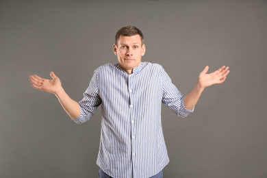 Photo of Emotional man in casual outfit on grey background