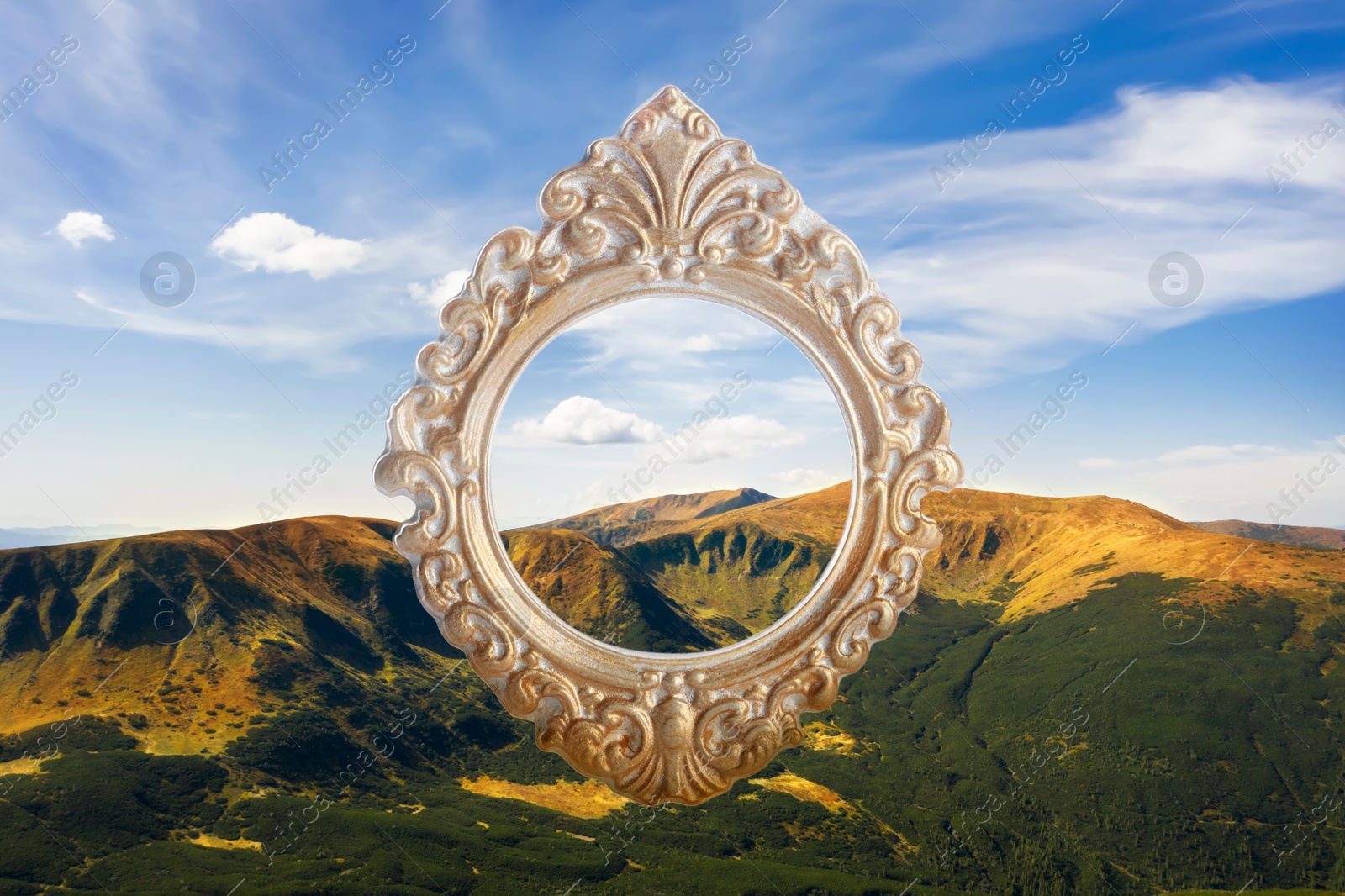 Image of Vintage frame and beautiful mountains under blue sky with clouds