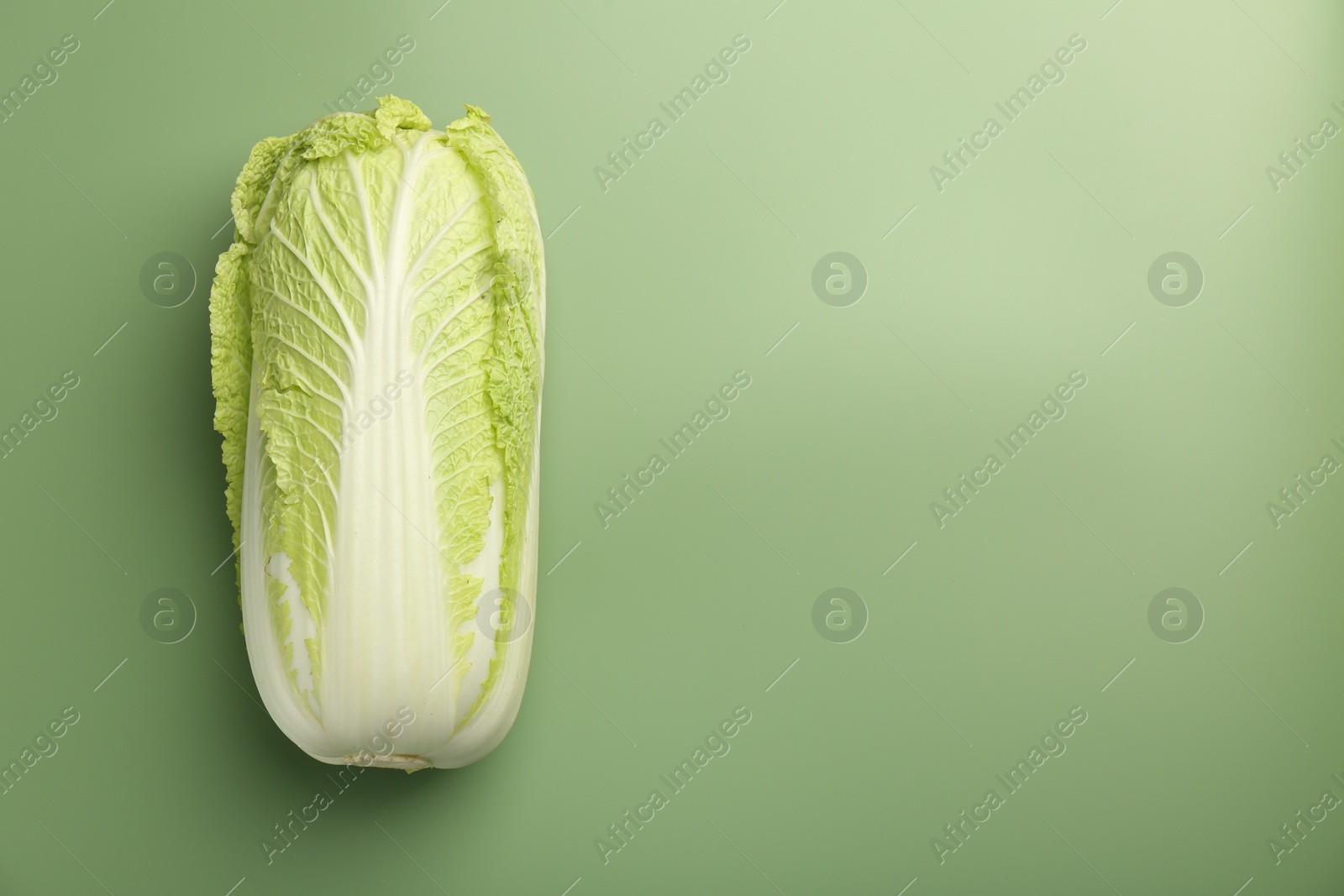 Photo of Fresh ripe Chinese cabbage on pale green background, top view. Space for text