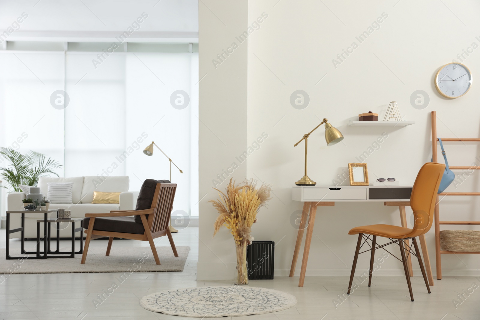 Photo of Living room and workplace in spacious apartment. Interior design