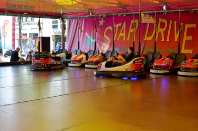 Photo of Netherlands, Groningen - May 18, 2022: Man driving electric bumper car in amusement park