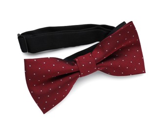 Photo of Stylish burgundy bow tie with polka dot pattern on white background