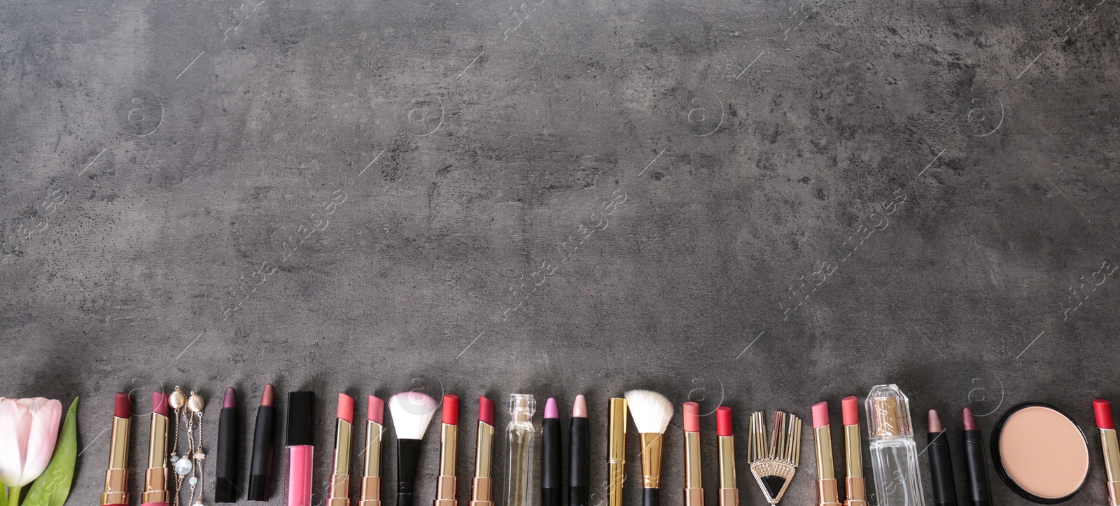 Photo of Flat lay composition with different lipsticks on grey background. Space for text