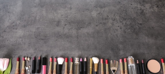 Flat lay composition with different lipsticks on grey background. Space for text