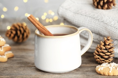 Composition with cup of hot winter drink on table. Cozy season