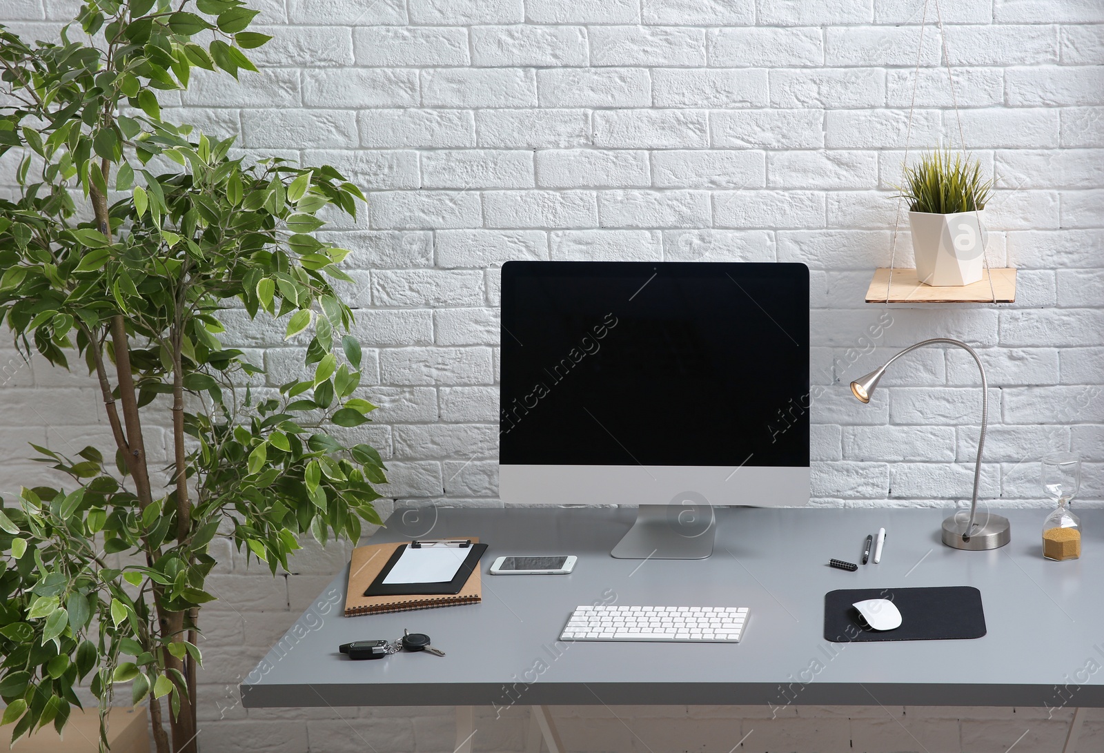 Photo of Interior of comfortable work place with computer on table at home