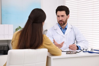 Photo of Doctor consulting patient during appointment in clinic