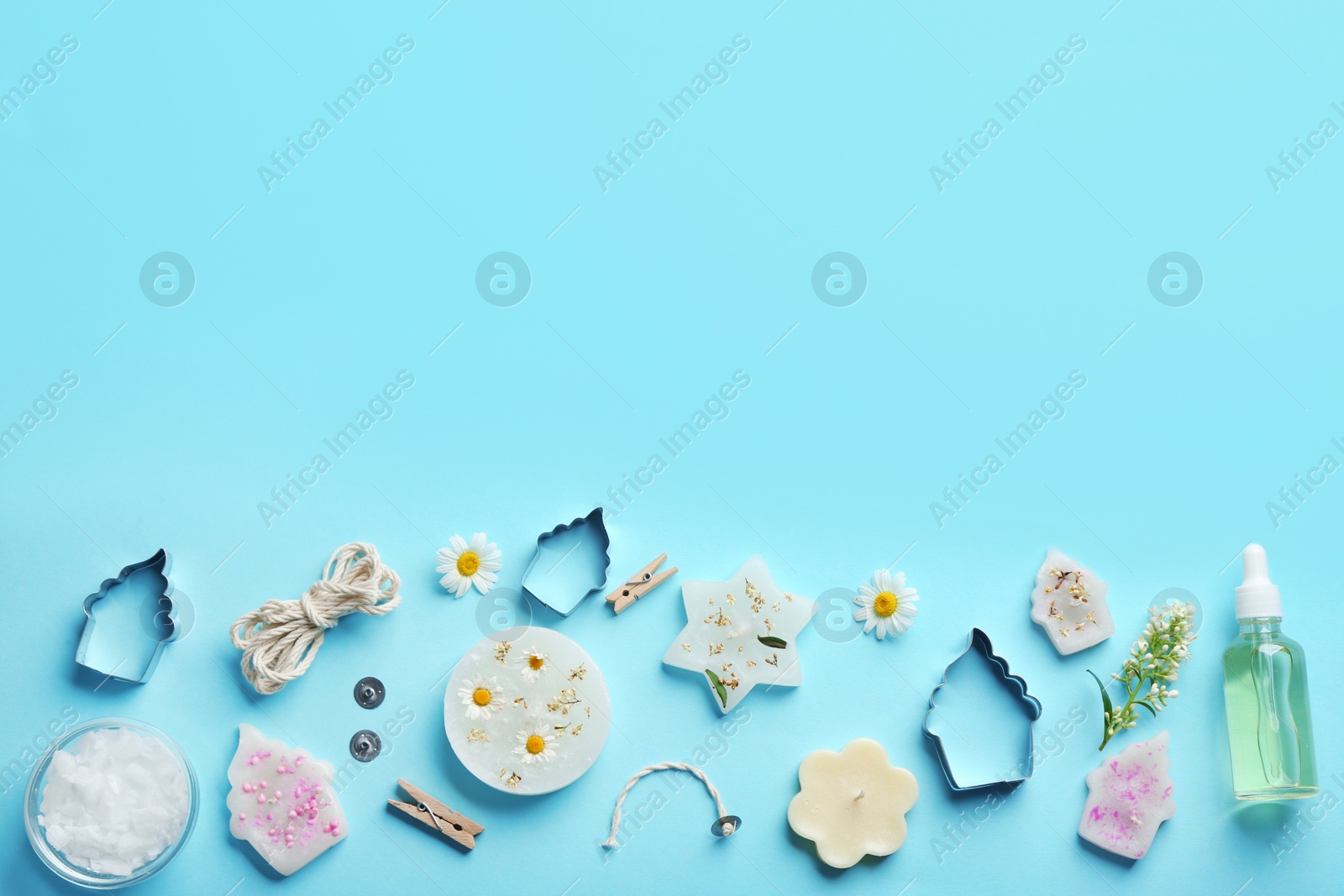 Photo of Flat lay composition with handmade candles and tools on color background. Space for text