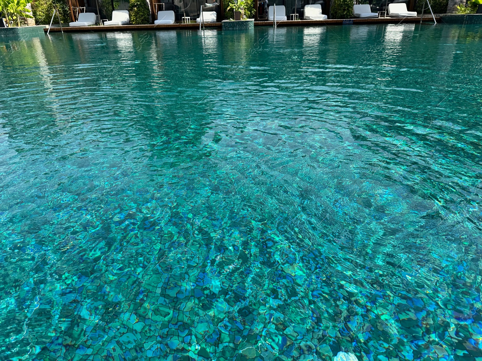 Photo of Swimming pool and sunbeds at luxury resort