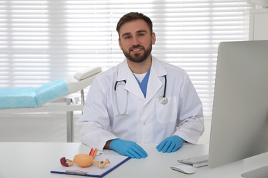 Photo of Portrait of young gynecologist at table in clinic