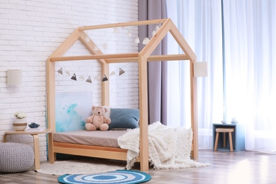 Photo of Stylish child room interior with cute wooden bed