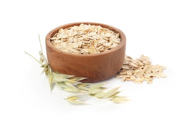 Photo of Wooden bowl with oatmeal and floret branches isolated on white